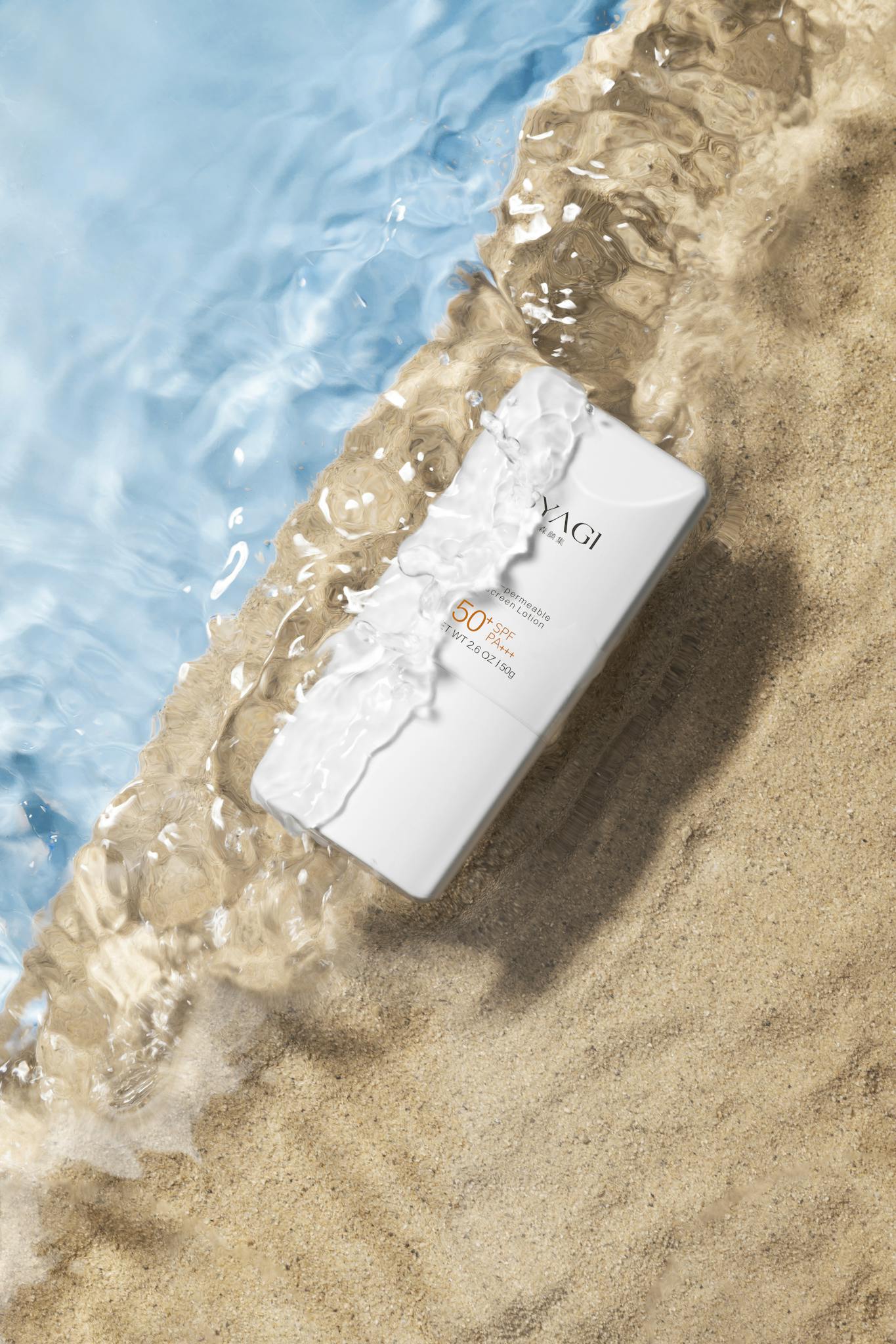 Close-up of sunscreen bottle on sand with water waves, ideal for summer skincare promotions.